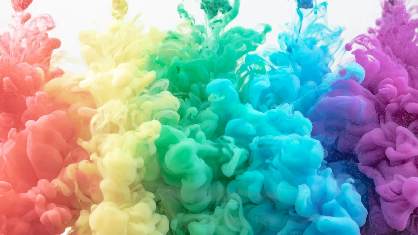 Clouds of brightly coloured ink spreading in water
