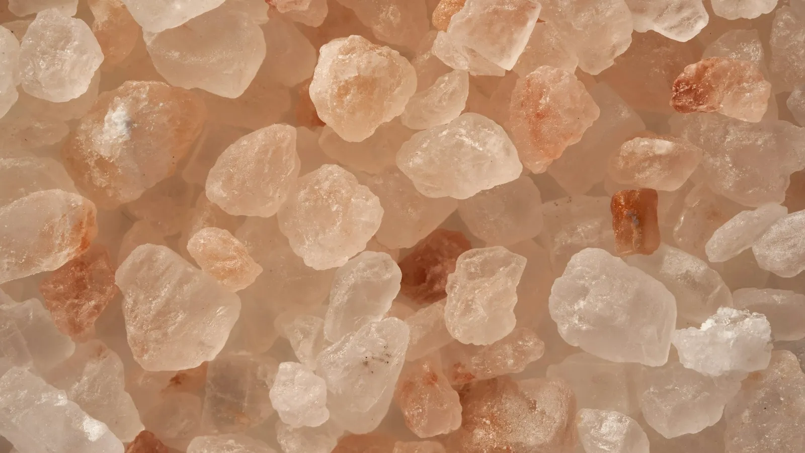 Coarse crystals of pink rock salt, close up