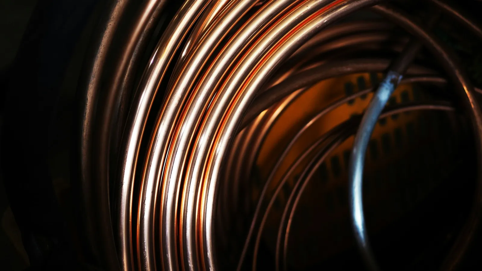 Coiled copper wire against a black background