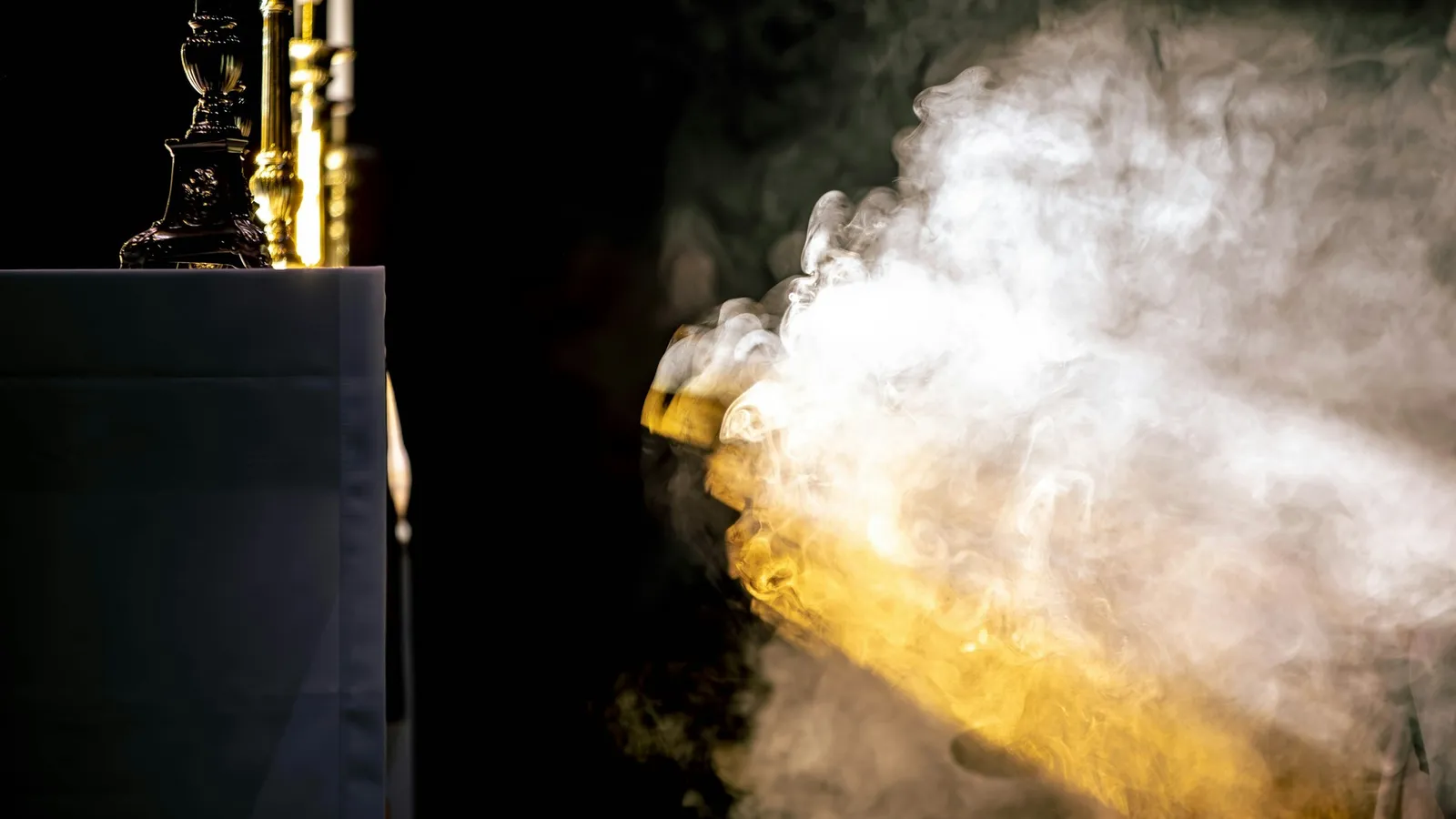 Cold white vapour pouring out against a dark background