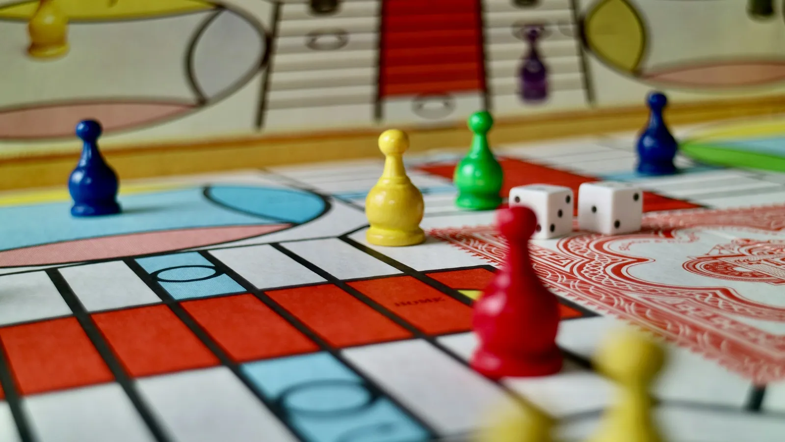 Colourful board game with playing pieces