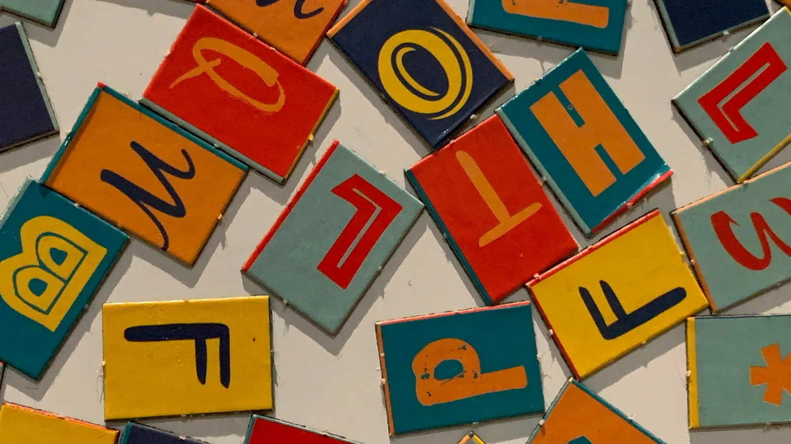 Colourful letter tiles scattered on a table