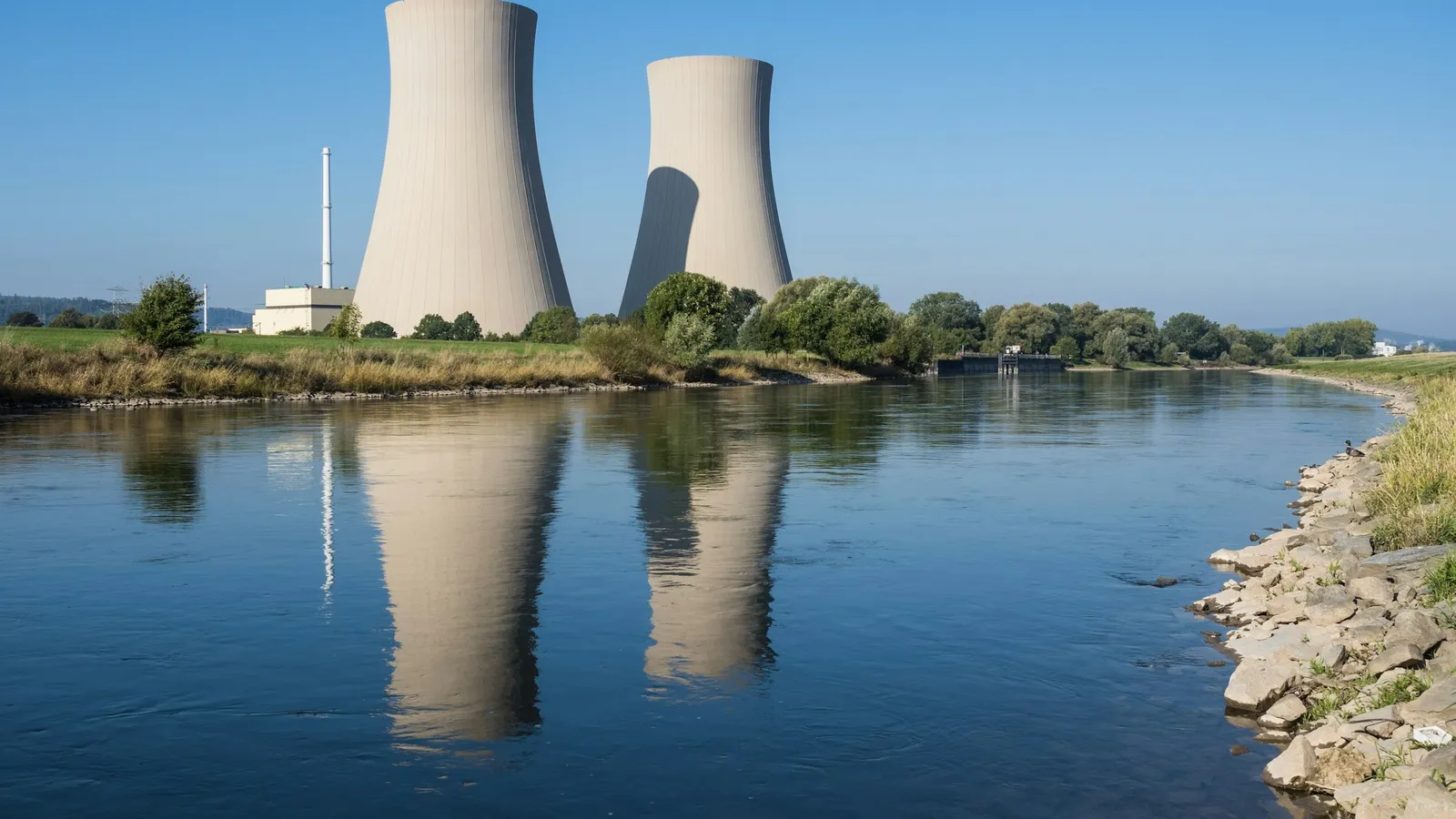 Cooling towers of a power station reflected in a river