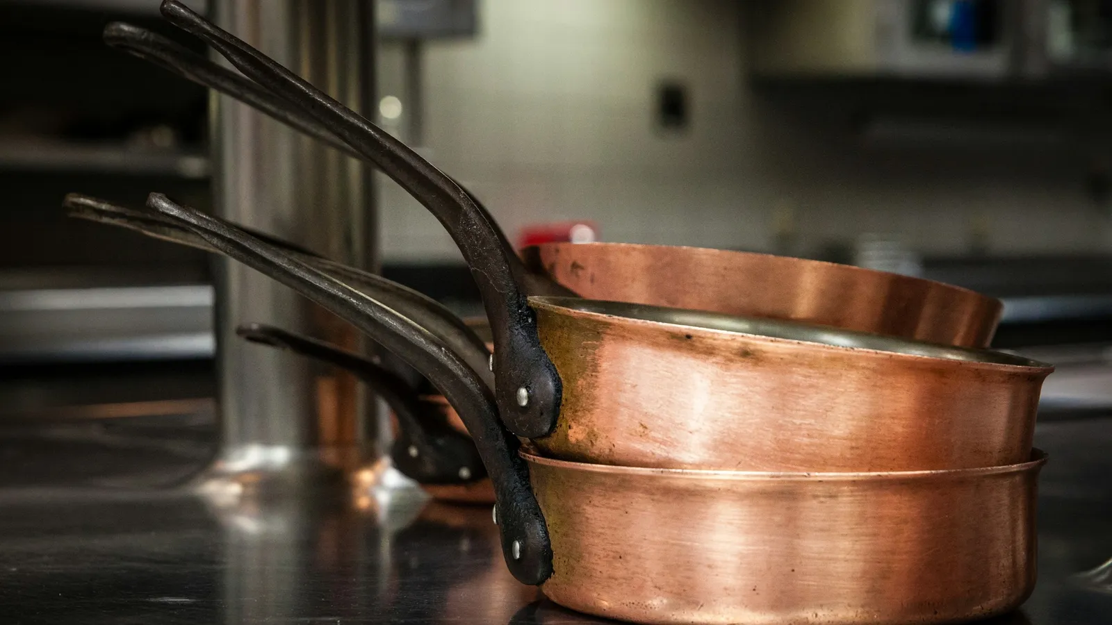 Copper-bottomed cooking pans on a stove
