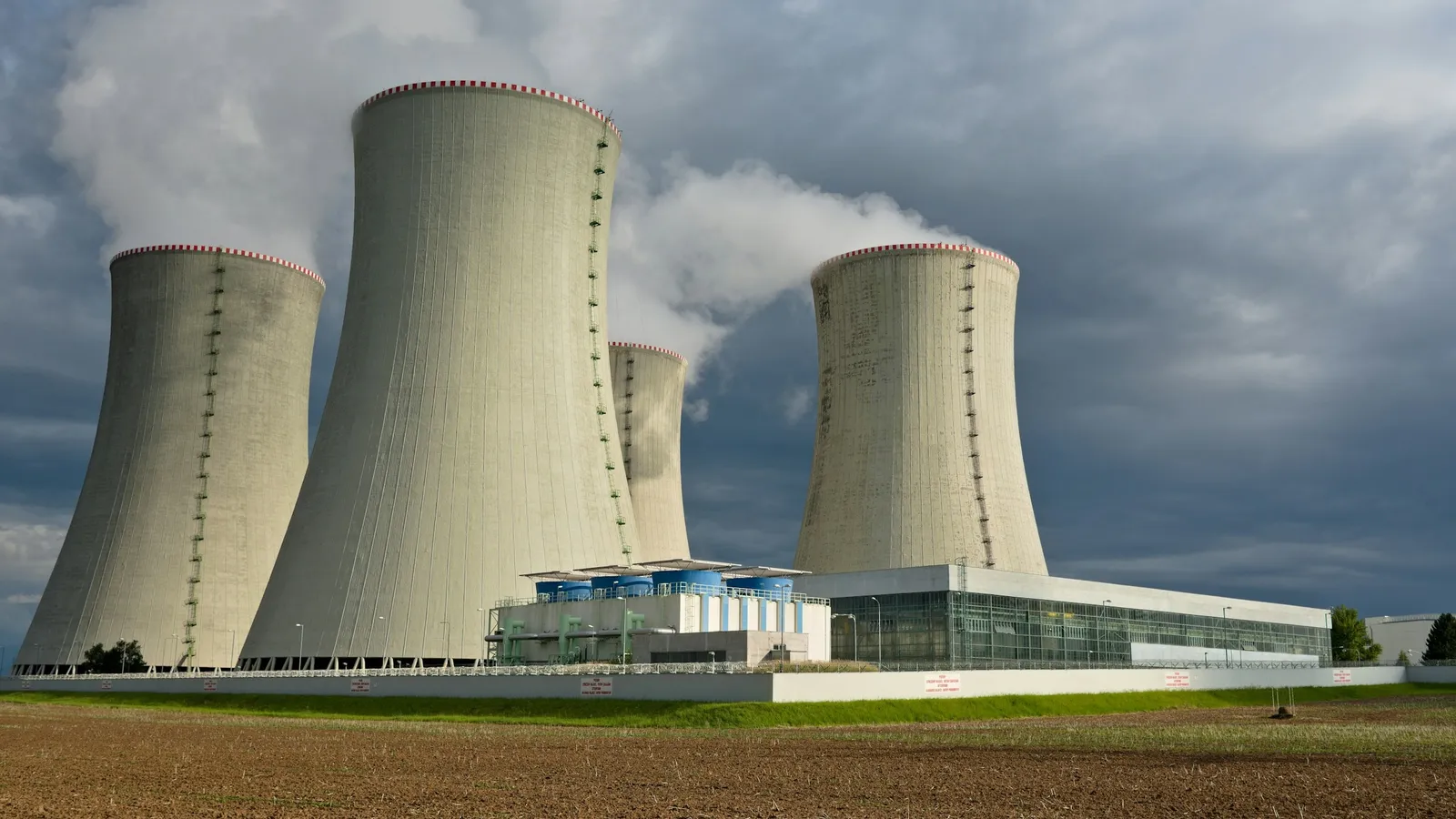 Curved cooling towers whose sides flare out at the top