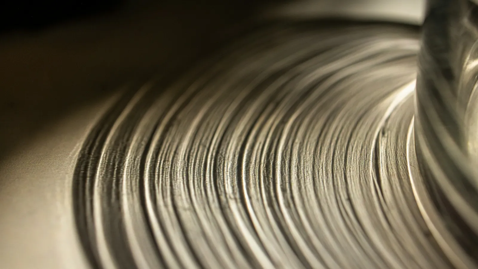 Curved silver metal sheets catching the light