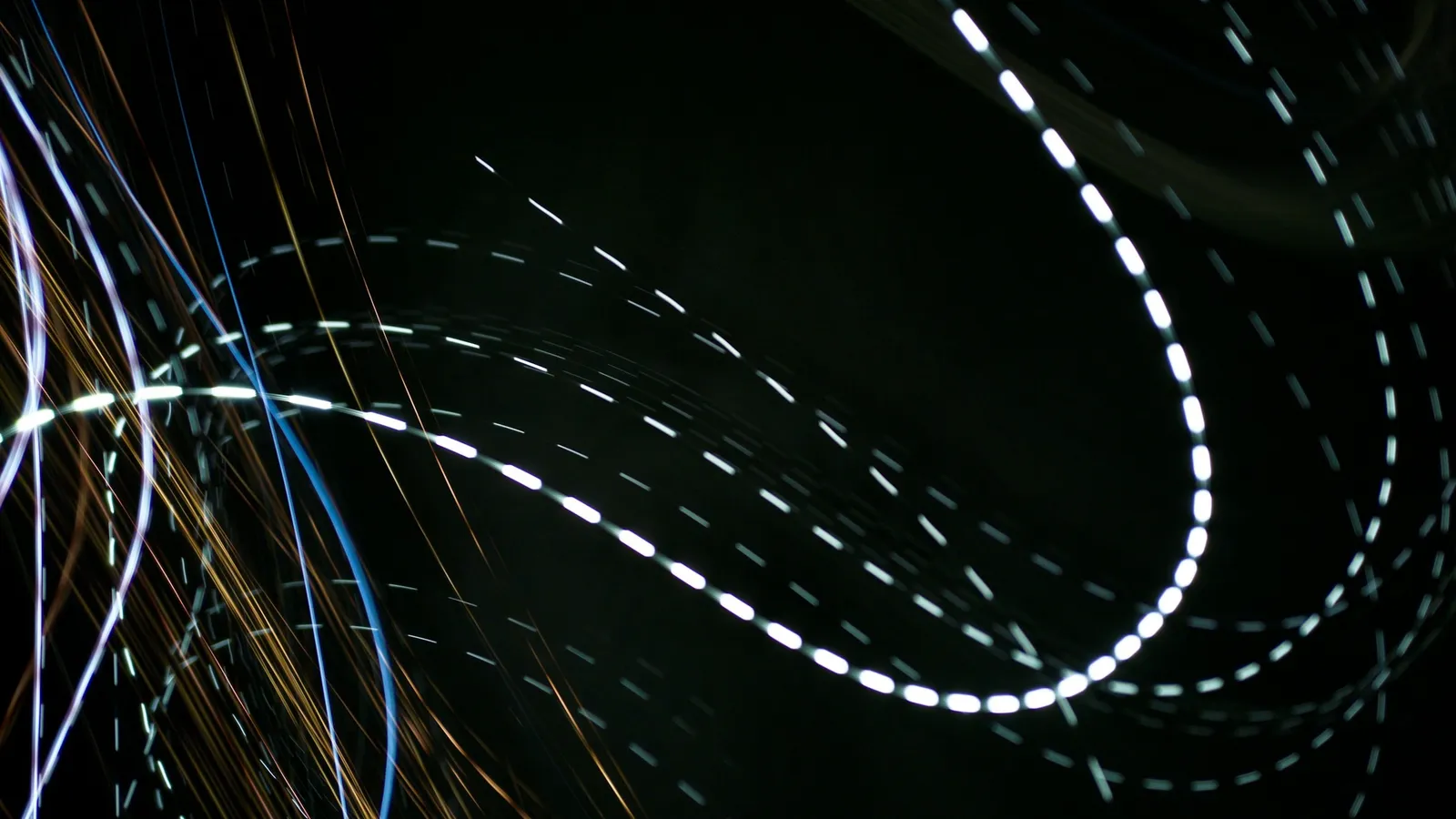 Curving streaks of light against a dark background