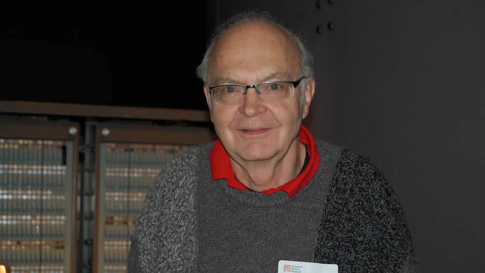 Donald Knuth in glasses and a grey sweater at the Computer History Museum
