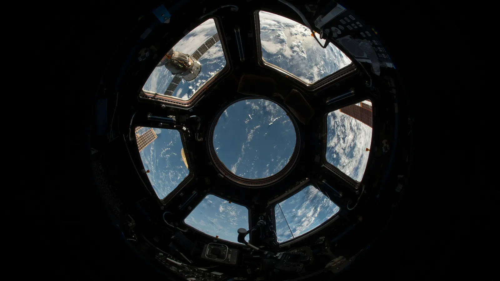Earth seen through the round windows of a space station