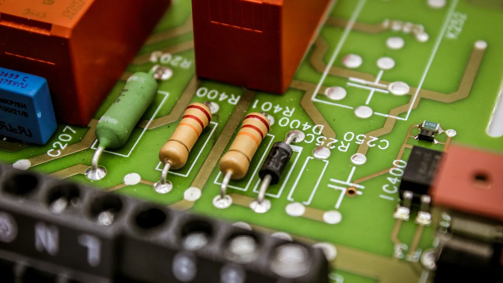 Electronic components soldered onto a green circuit board