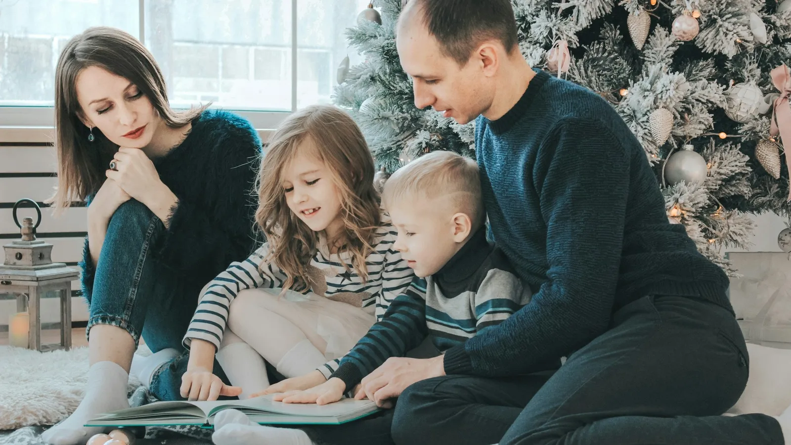 Family sitting on the floor reading together