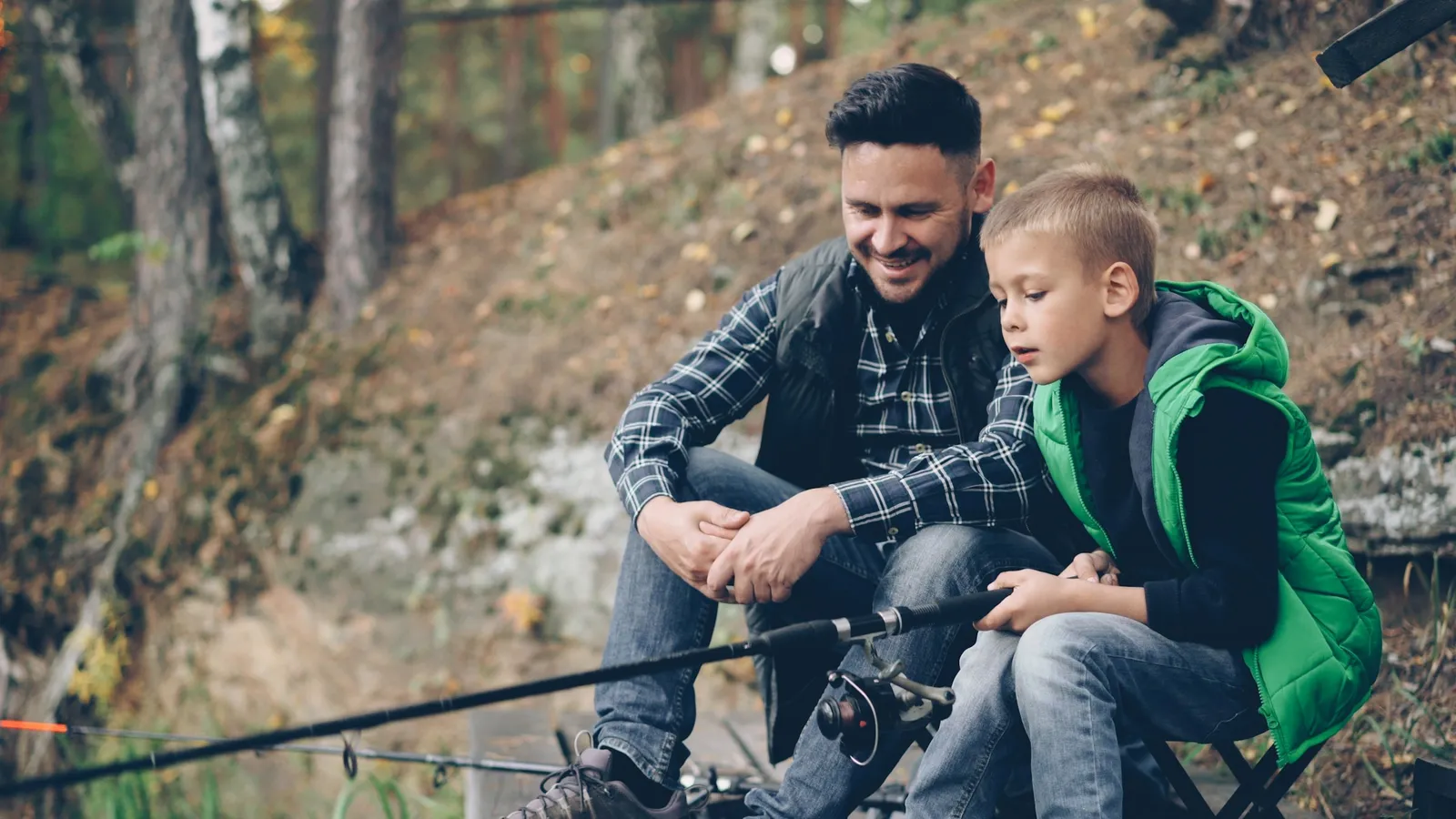 Father and son talking while fishing