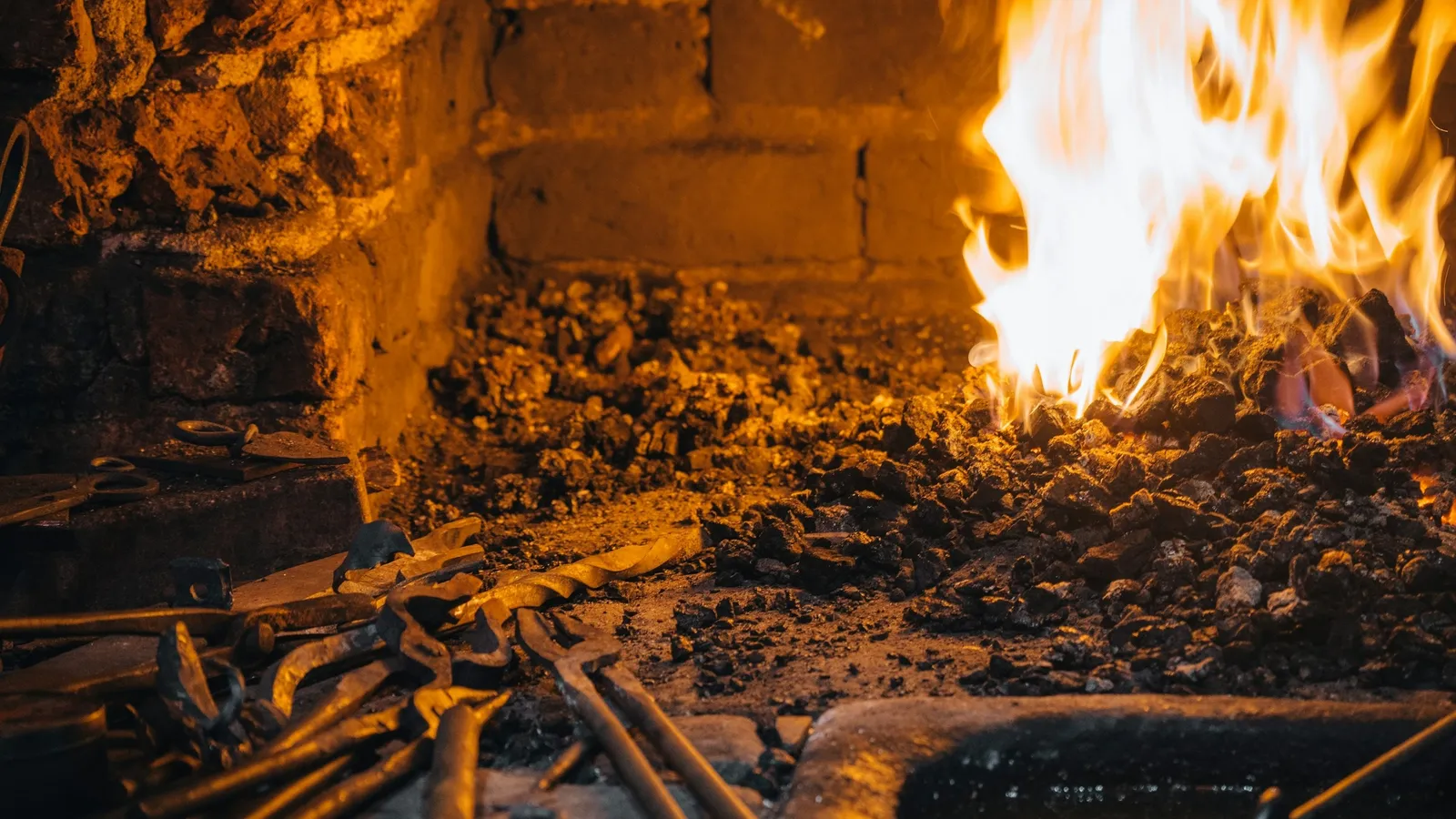 Flames glowing inside a brick forge