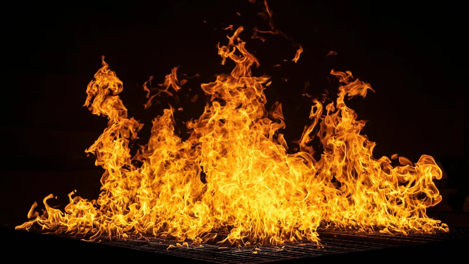 Flames rising from a fire against black