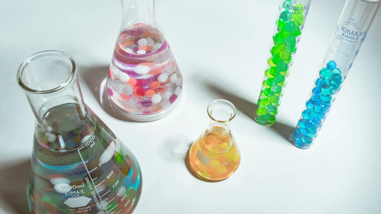 Flasks and test tubes holding colourful beads and liquids