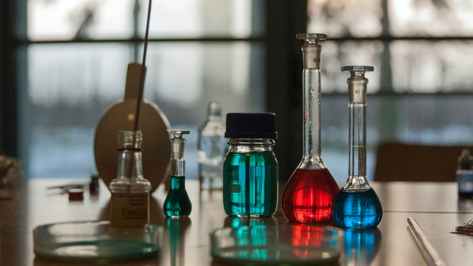 Flasks of red, blue and green solutions on a lab bench