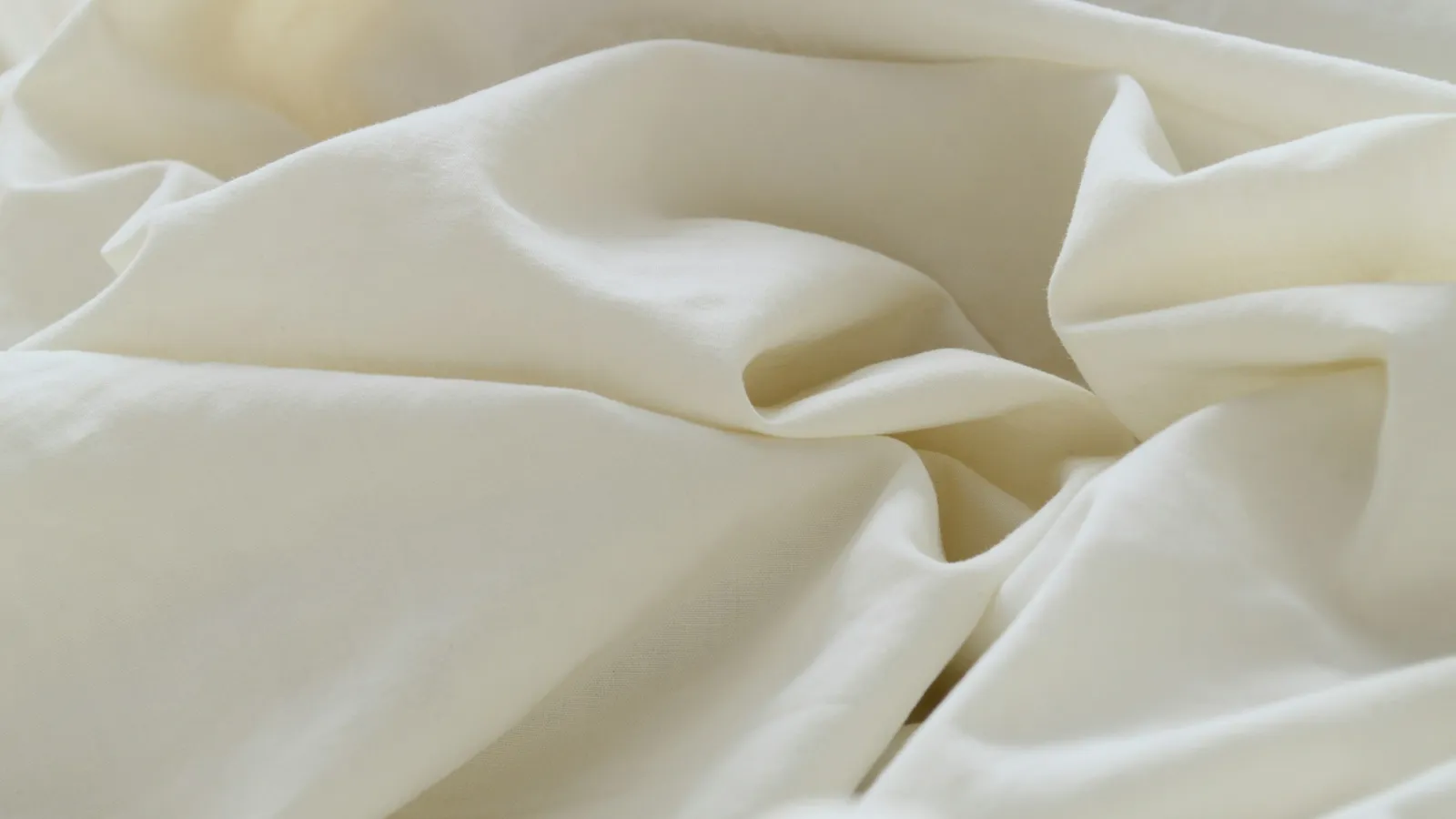 Folds of smooth cream-coloured fabric