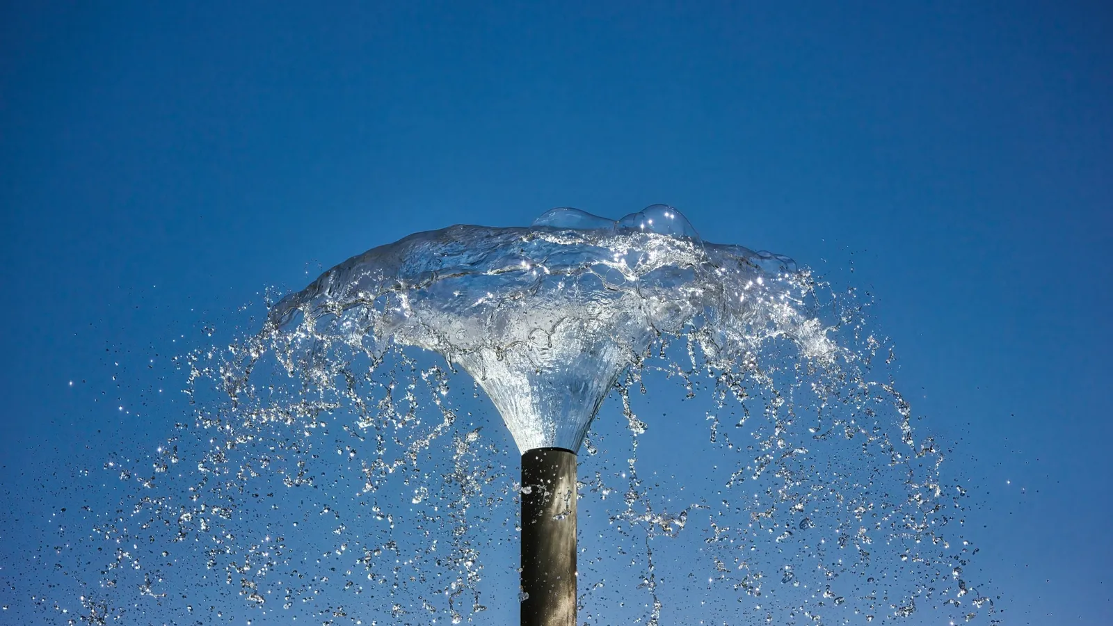 Fountain jets arcing against a blue sky
