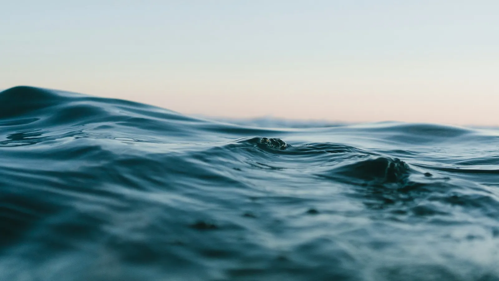 Gentle waves on a calm sea at dawn