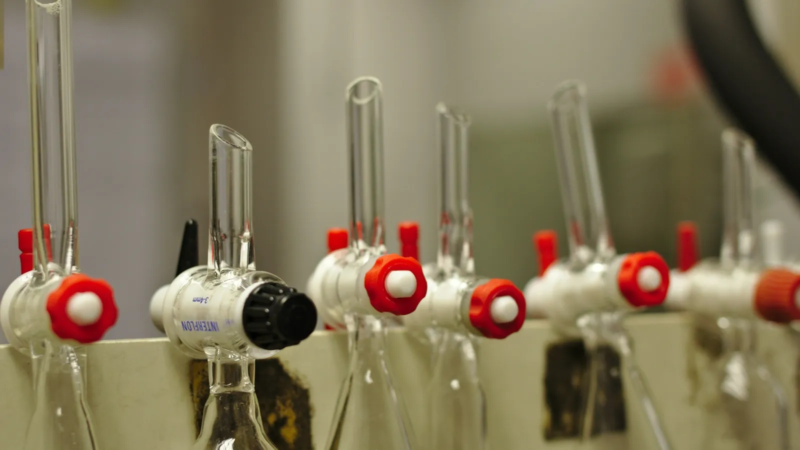 Glass columns with red stopcocks in a lab