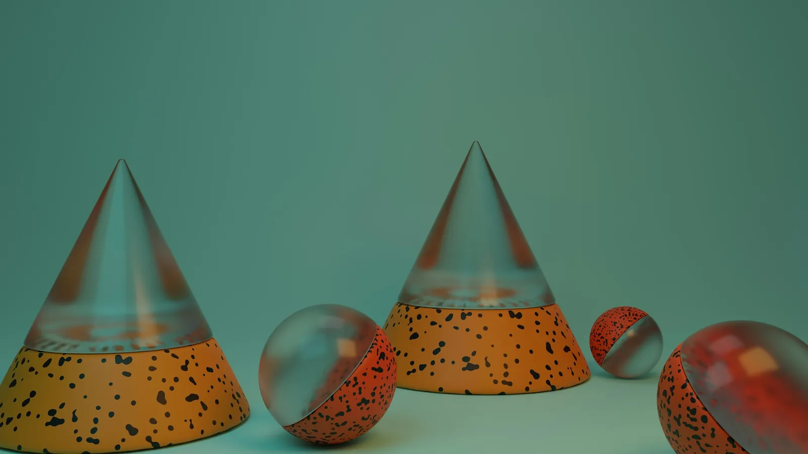 Glass cones and spheres arranged on a teal surface