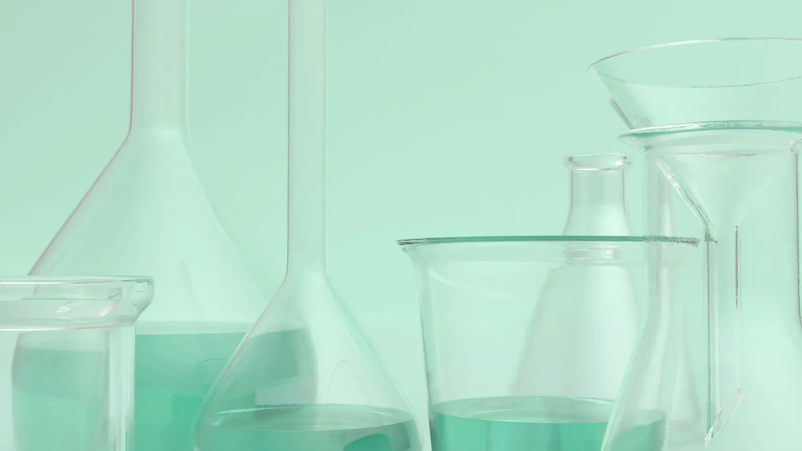 Glass flasks holding pale green liquid