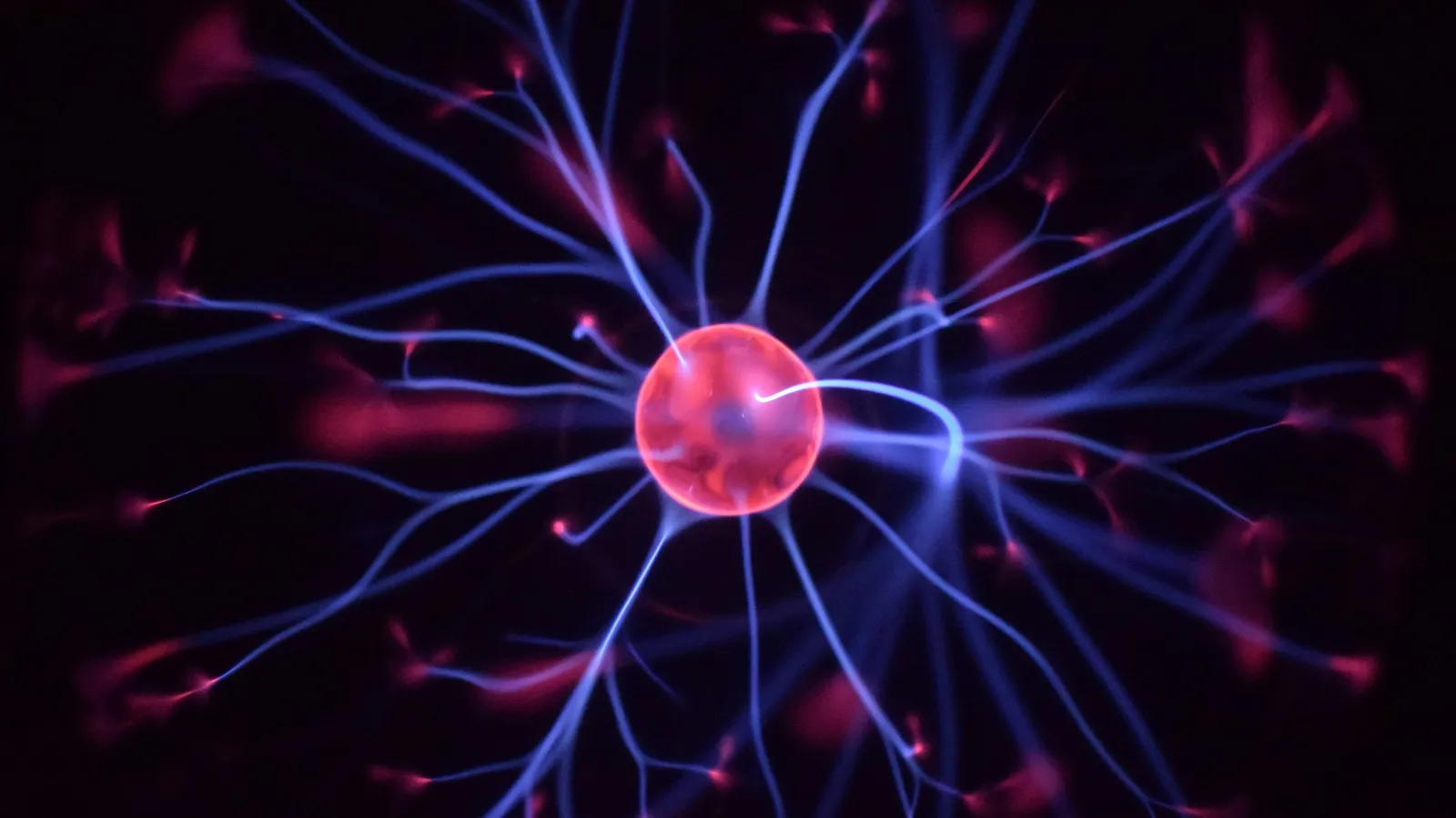 Glowing filaments of plasma inside a glass plasma ball