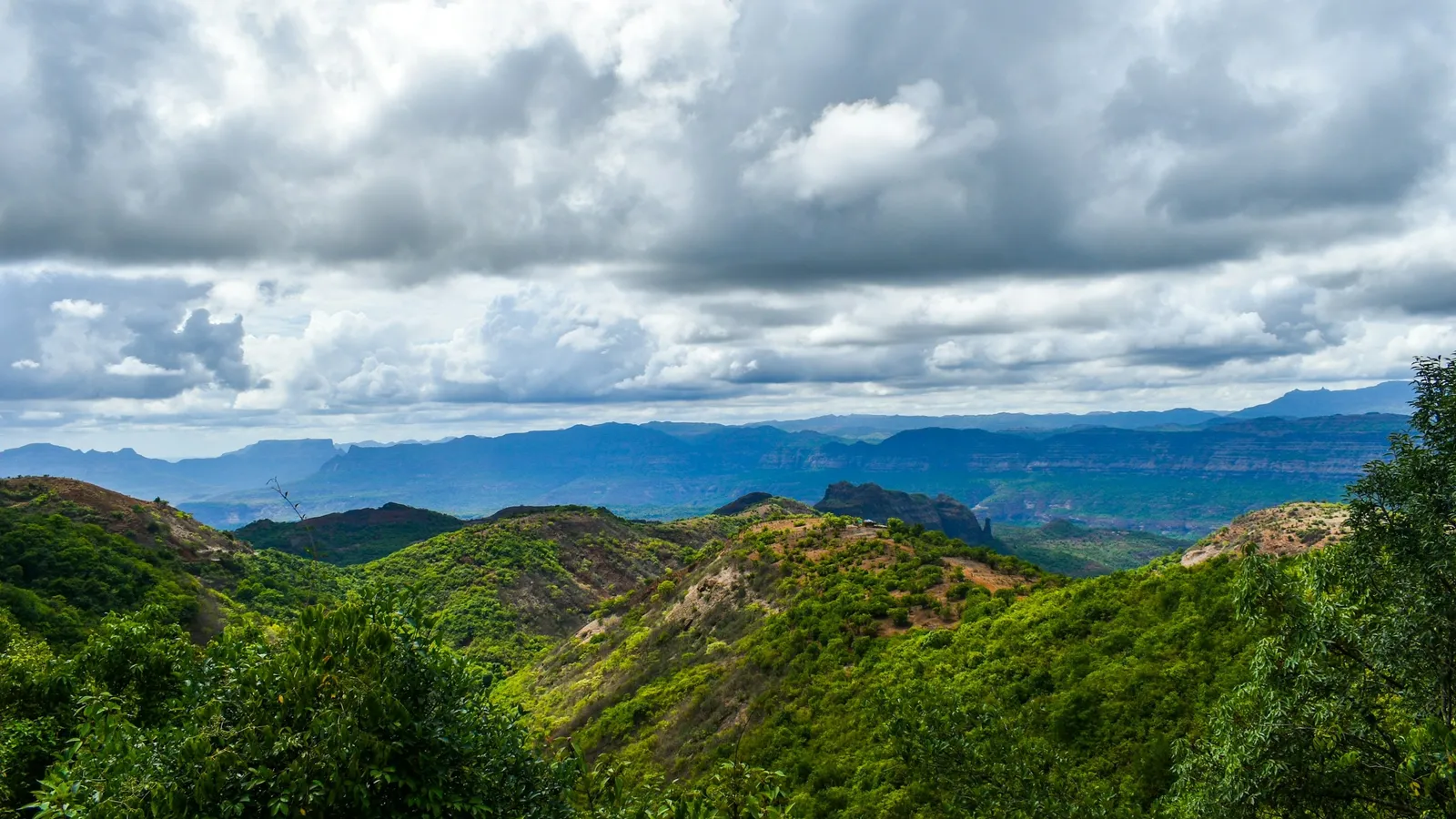 Green forested hills of the Western Ghats under clouds