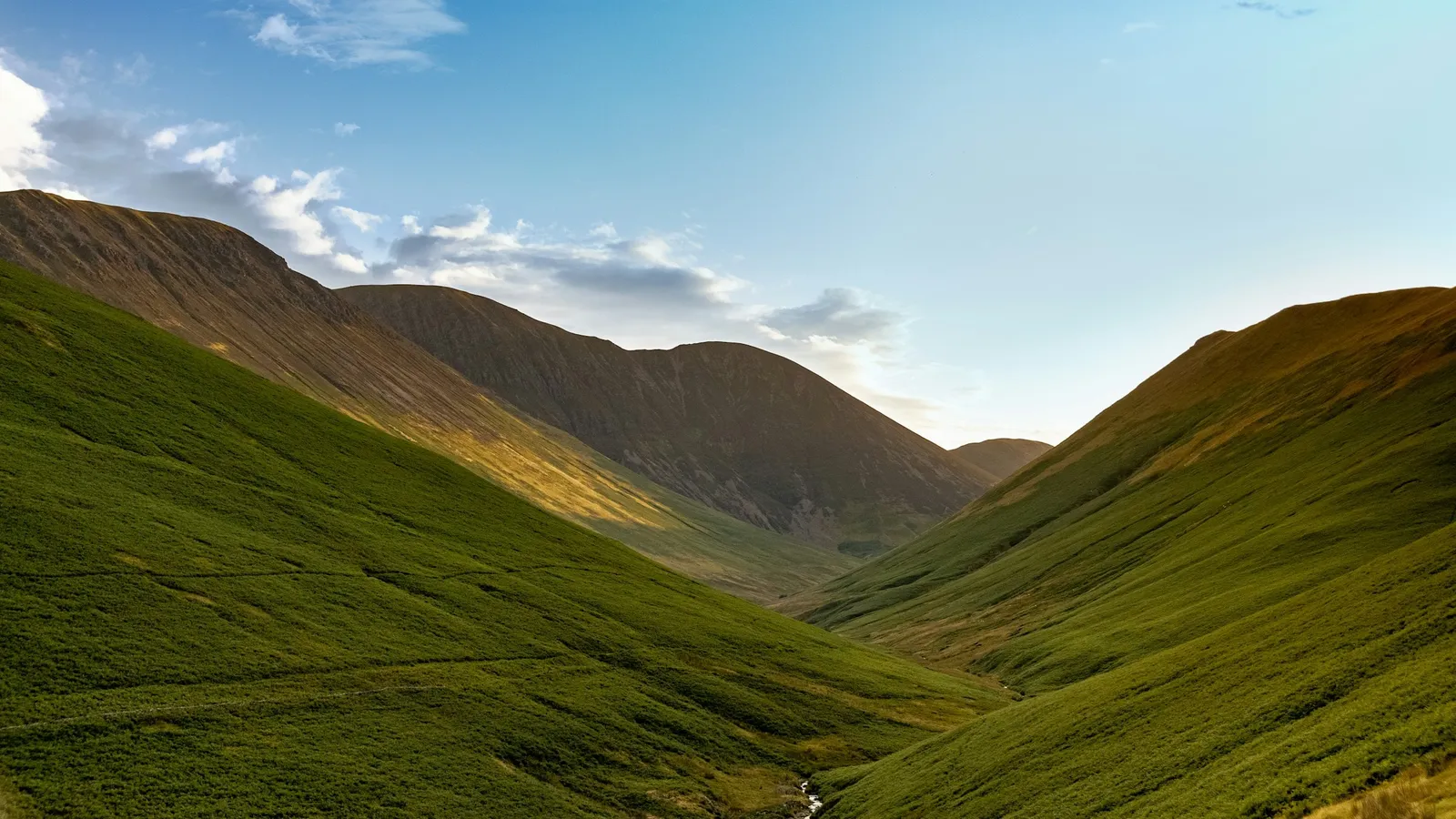 Green hills rising and falling along a valley