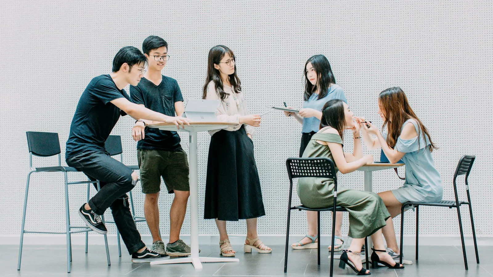Group of students standing and discussing a question