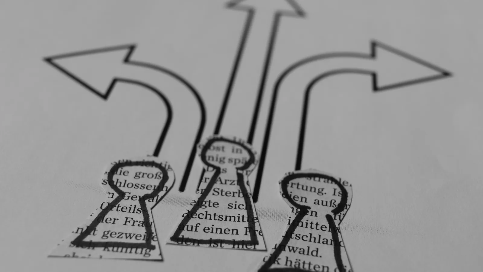 Hand-drawn arrows branching in different directions on paper