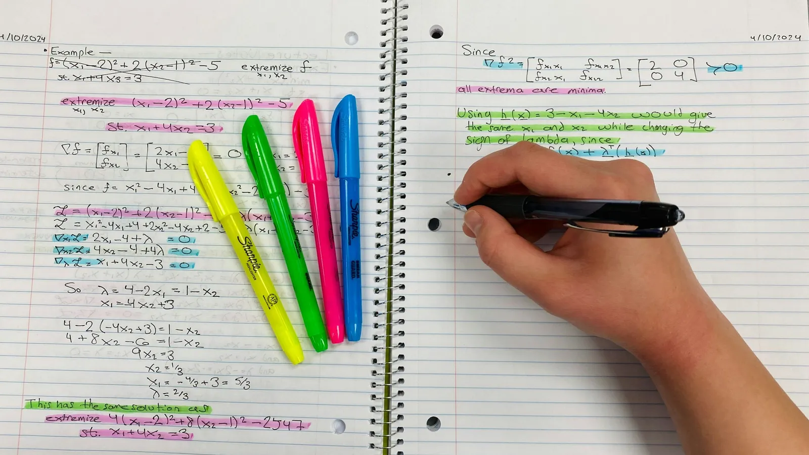 Hand highlighting notes with coloured highlighters