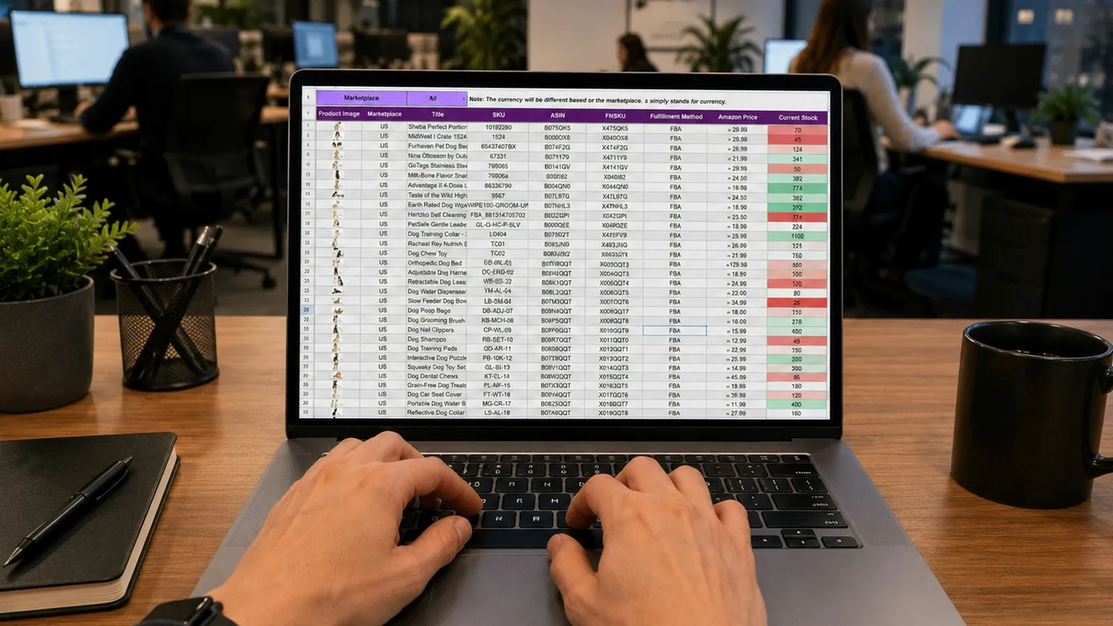 Hands typing on a laptop showing a data spreadsheet