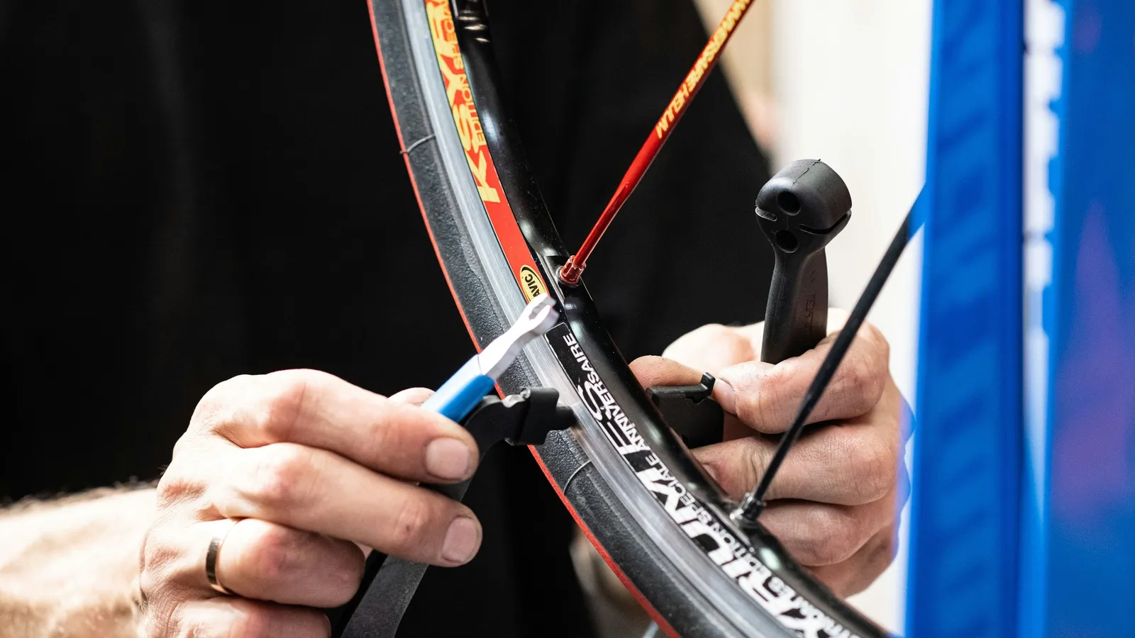 Hands using a pump to inflate a bicycle tyre