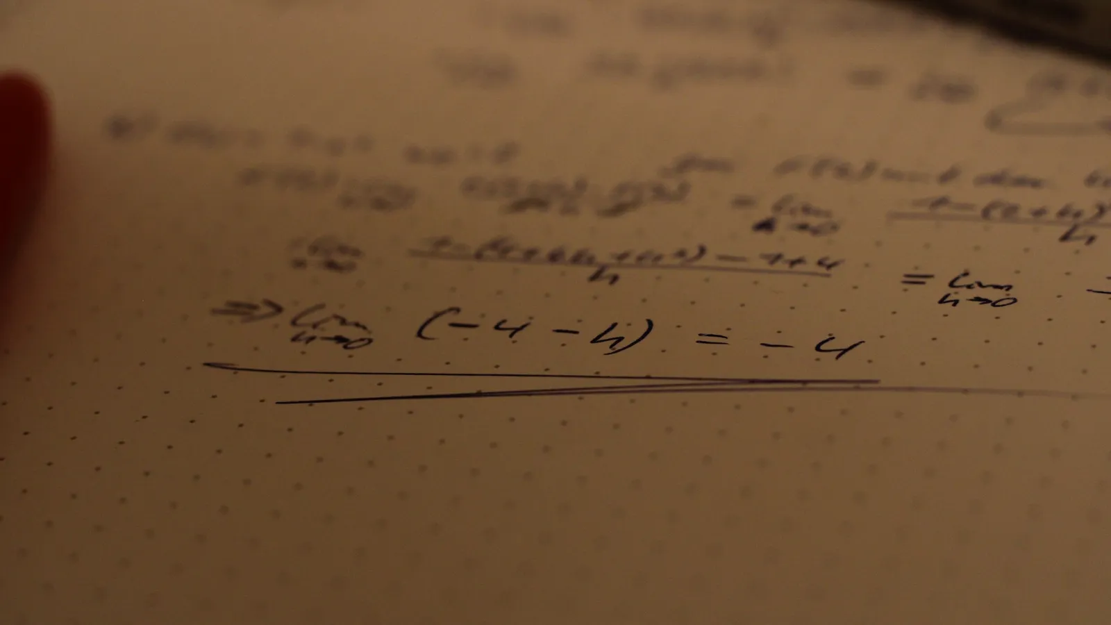Handwritten maths working on paper