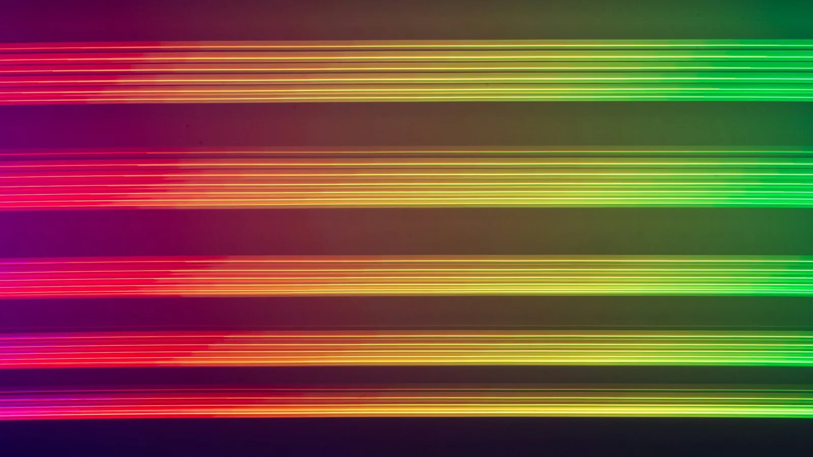 Horizontal bands of coloured light against a dark background, like a spectrum