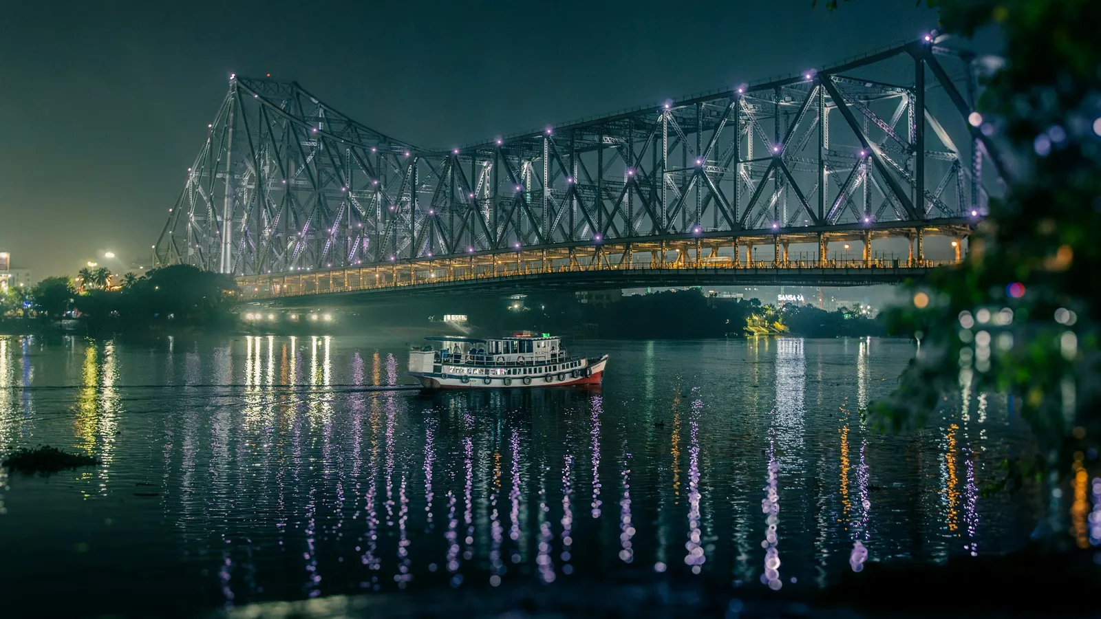 Howrah Bridge lit up at night over the river