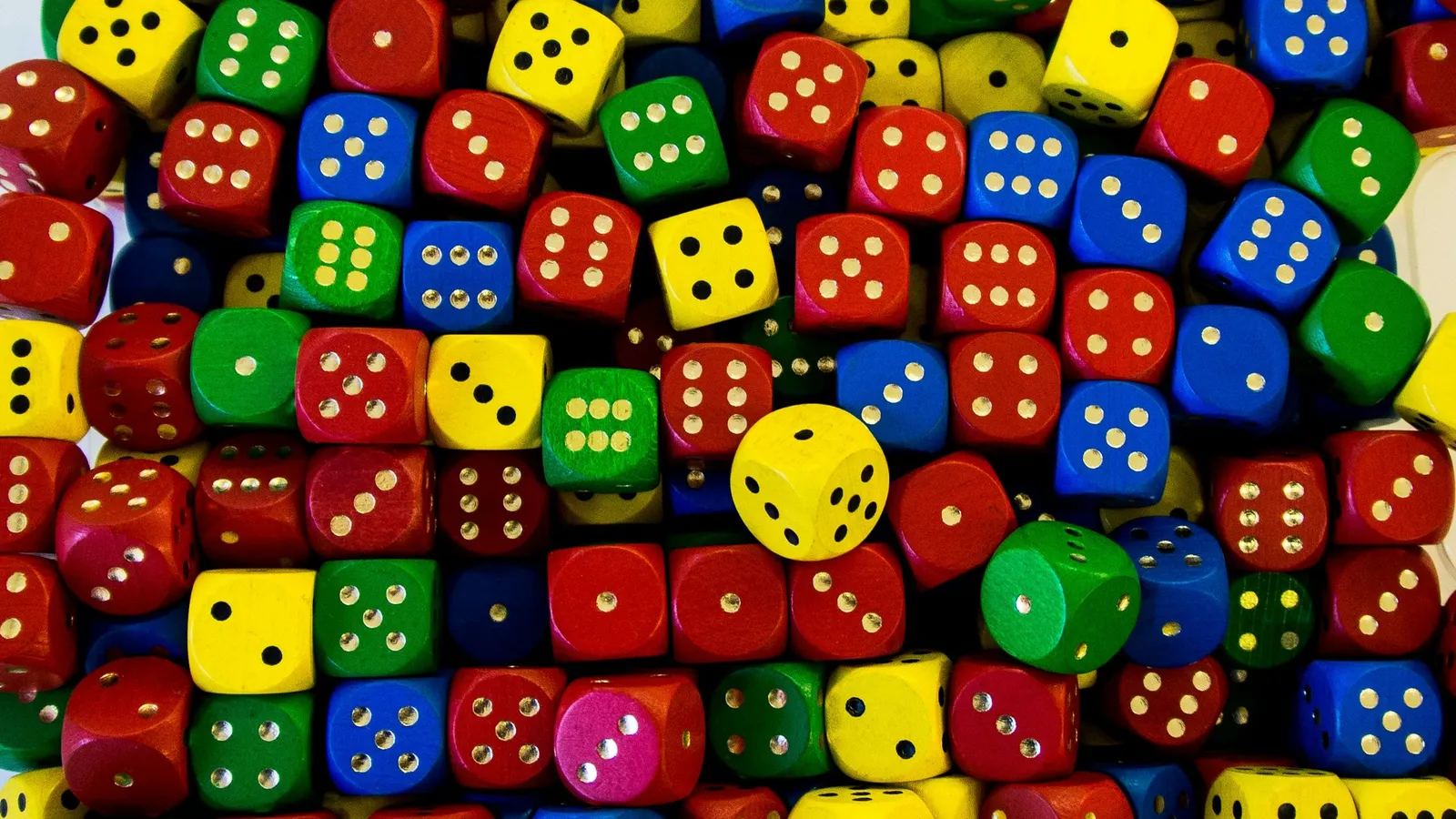Hundreds of colourful dice piled together