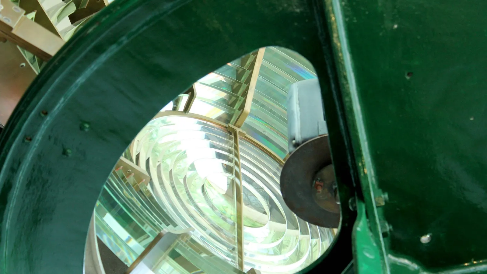 Inside a lighthouse lantern, looking through its large glass lens
