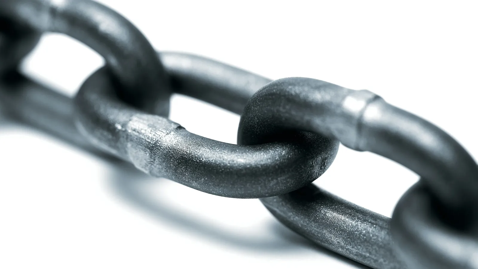Interlocking metal chain links on white