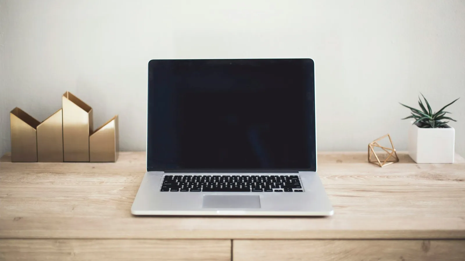 Laptop open on a wooden desk