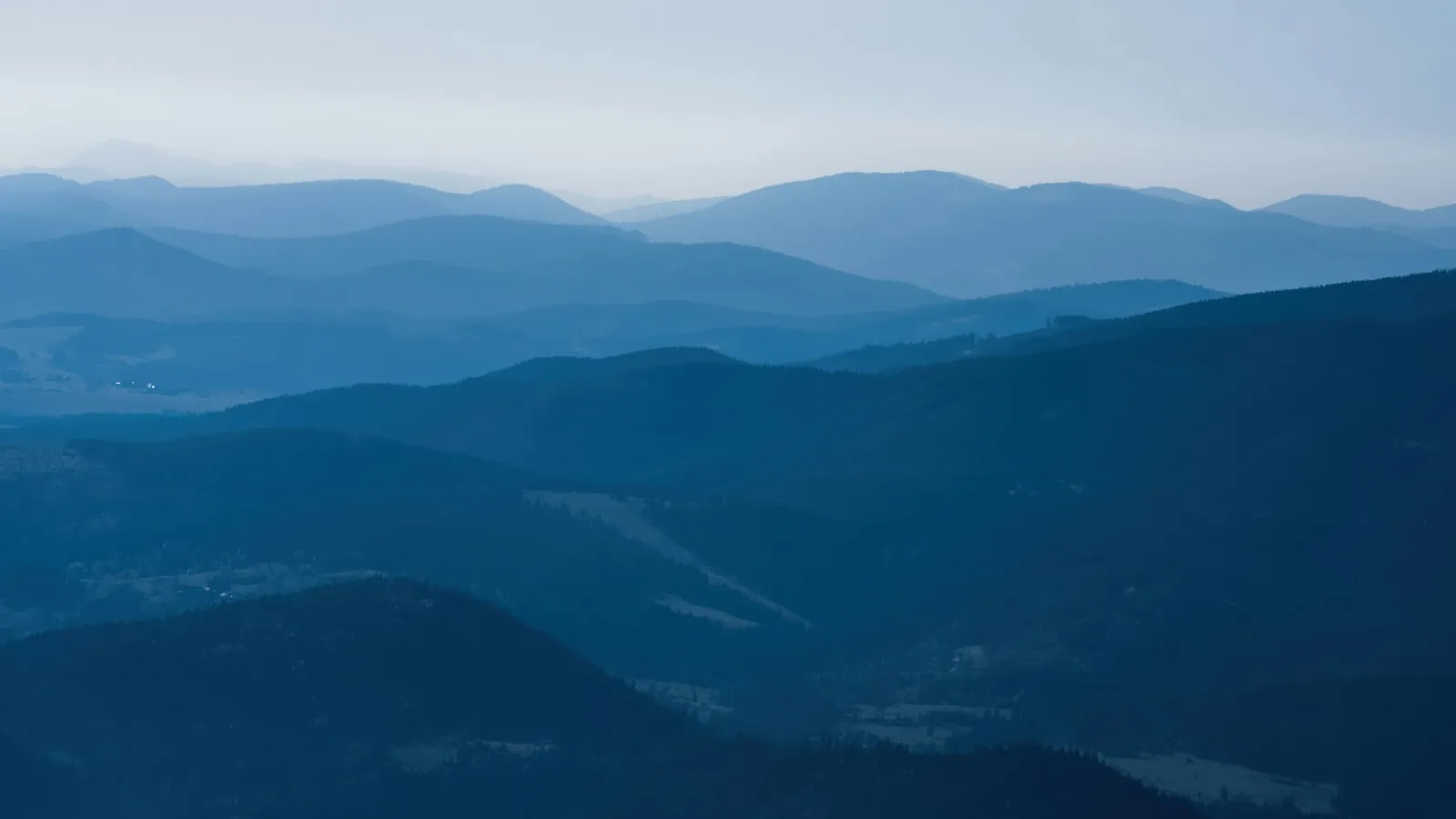 Layers of blue mountain ridges fading towards the horizon