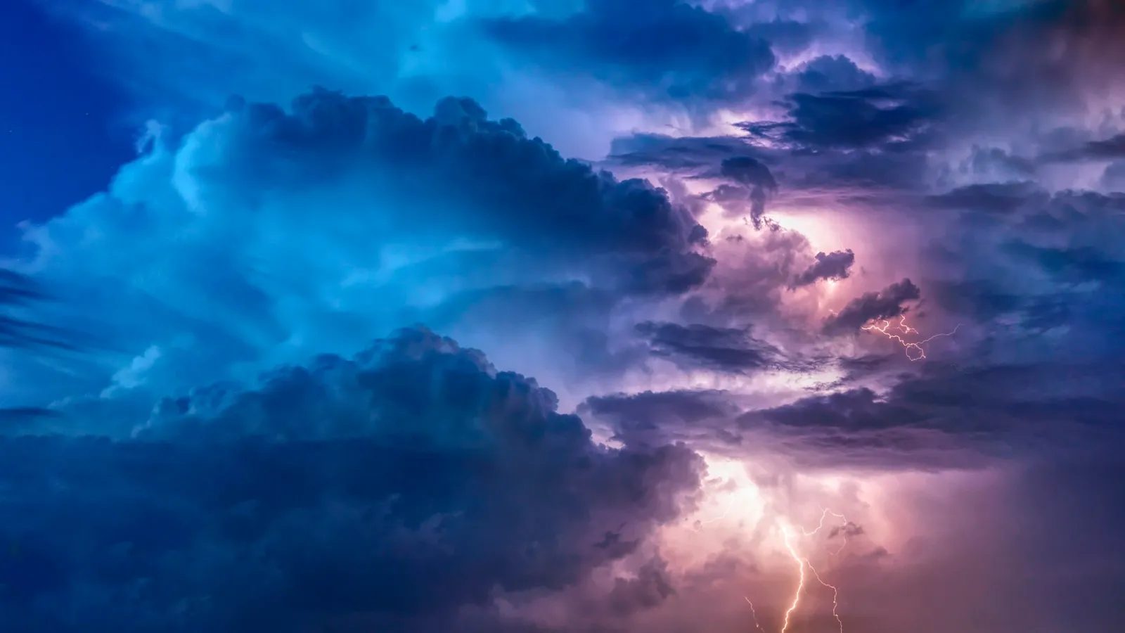 Lightning flashing inside storm clouds