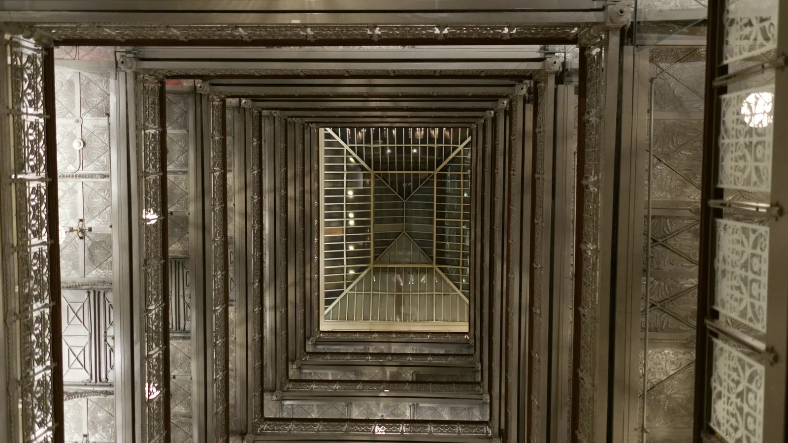 Looking up an old lift shaft lined with metal frames