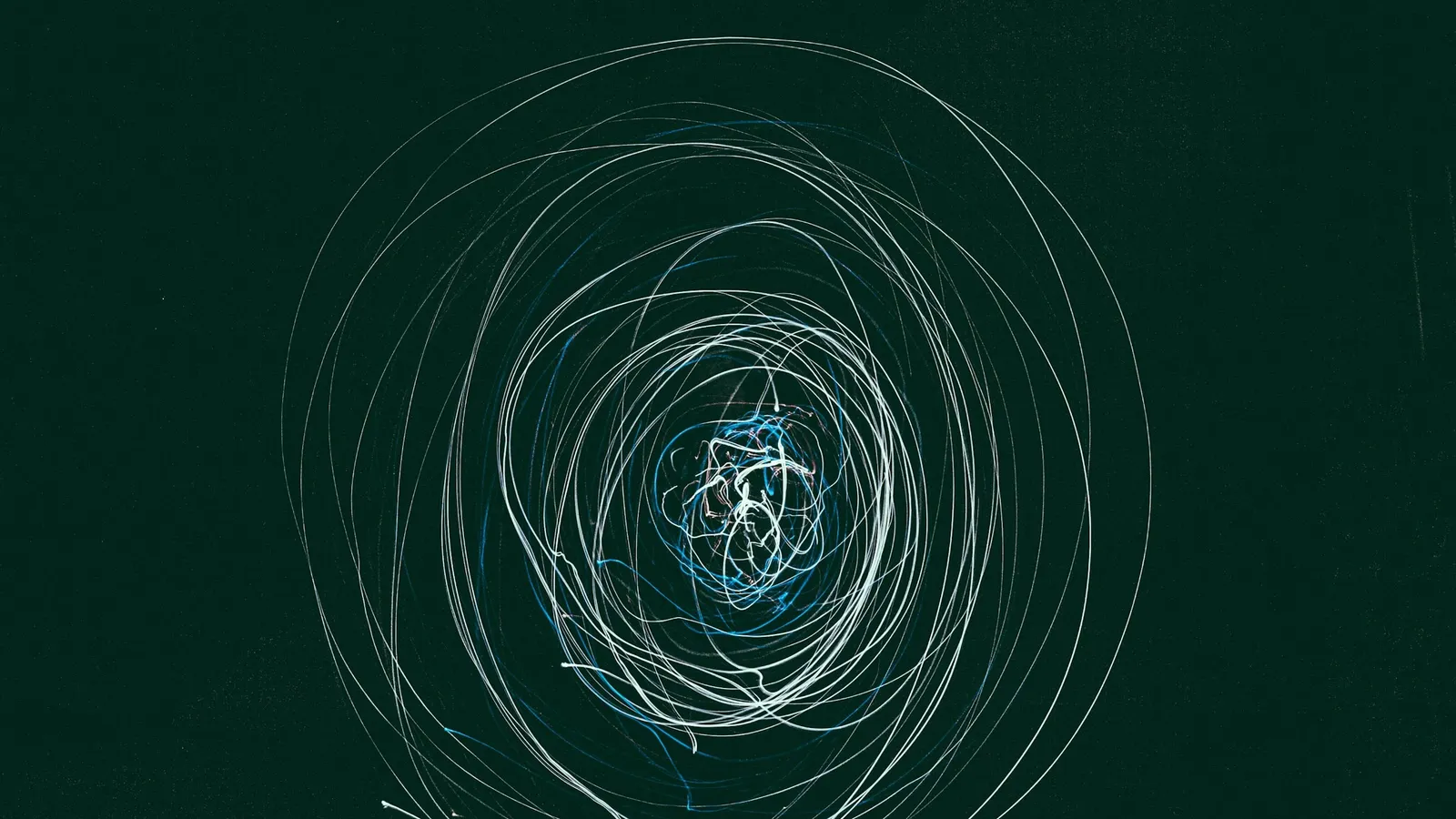 Looping chalk circles drawn on a green chalkboard