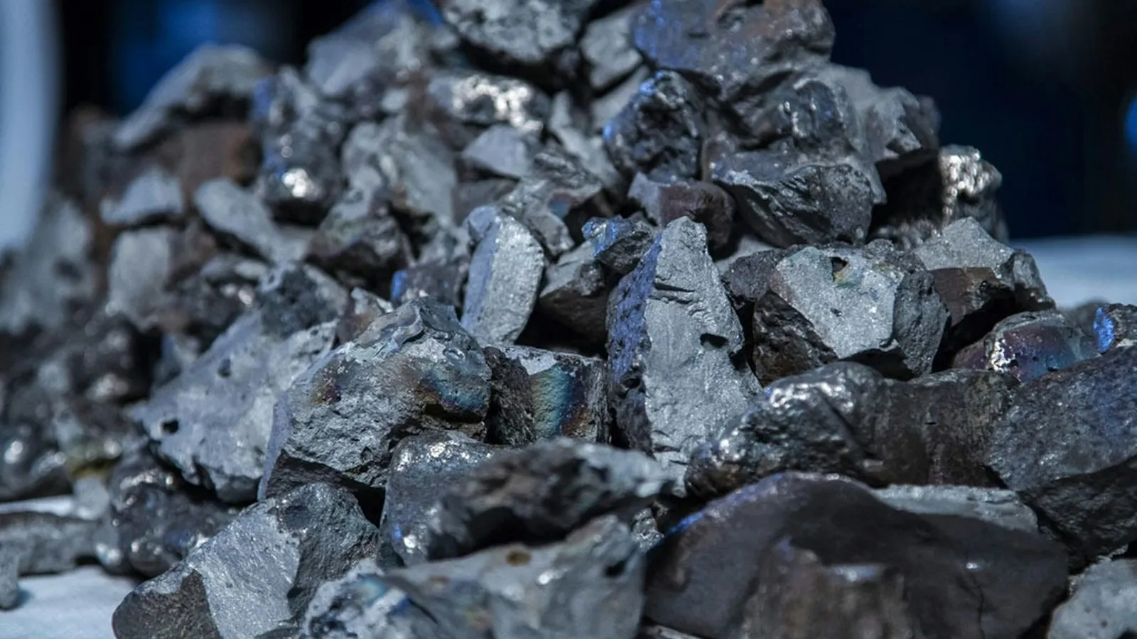 Lumps of grey metal on a dark surface