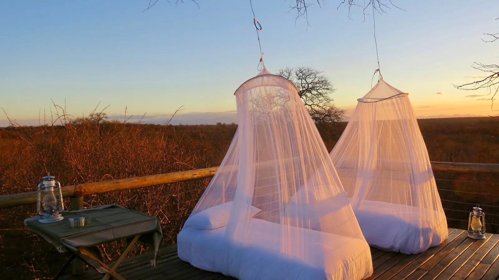 Mosquito nets hung over beds on an open deck