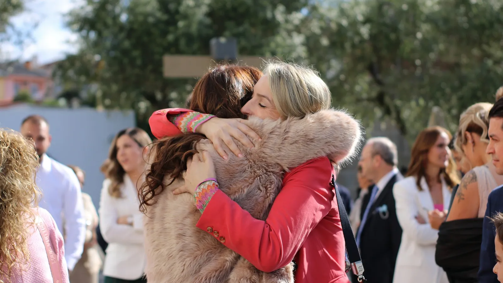Mother and daughter hugging at an event