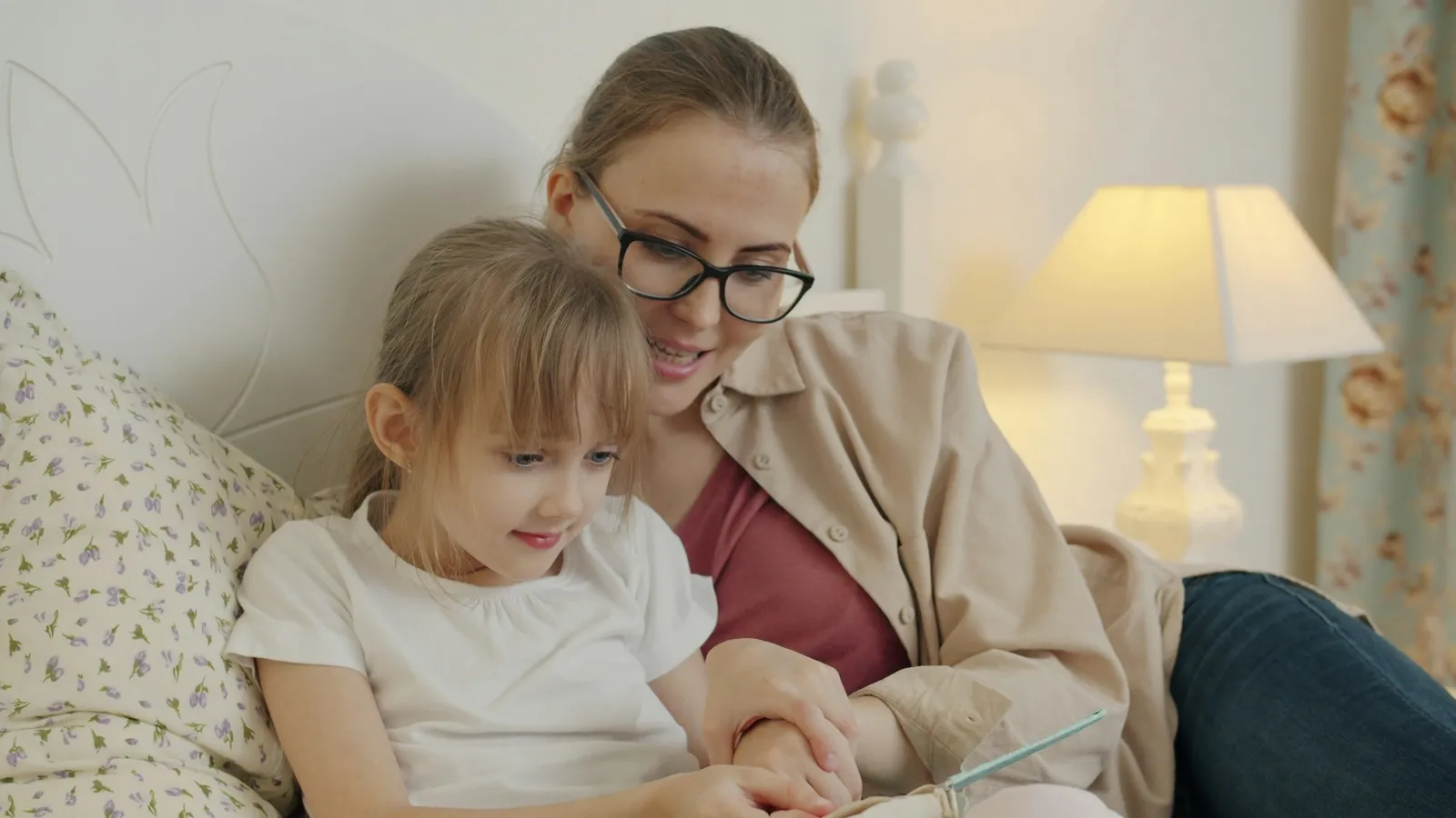 Mother reading a book with her young daughter