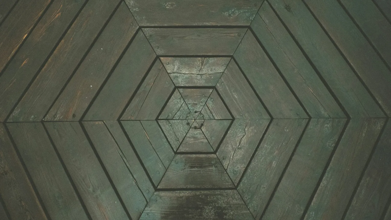 Nested hexagons cut into a dark stone surface